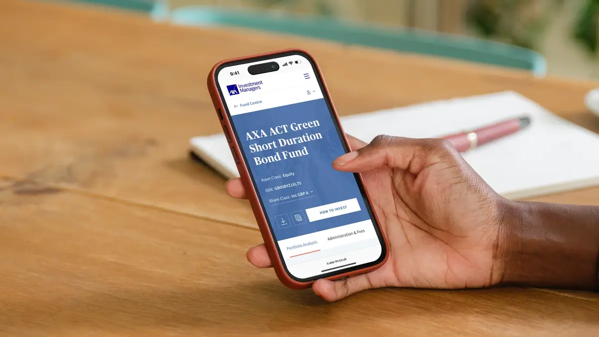 Hand holding a phone showing the AXA ACT Green Short Duration Bond Fund page