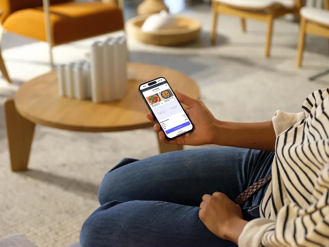 Person on a sofa testing a Gousto prototype on their phone