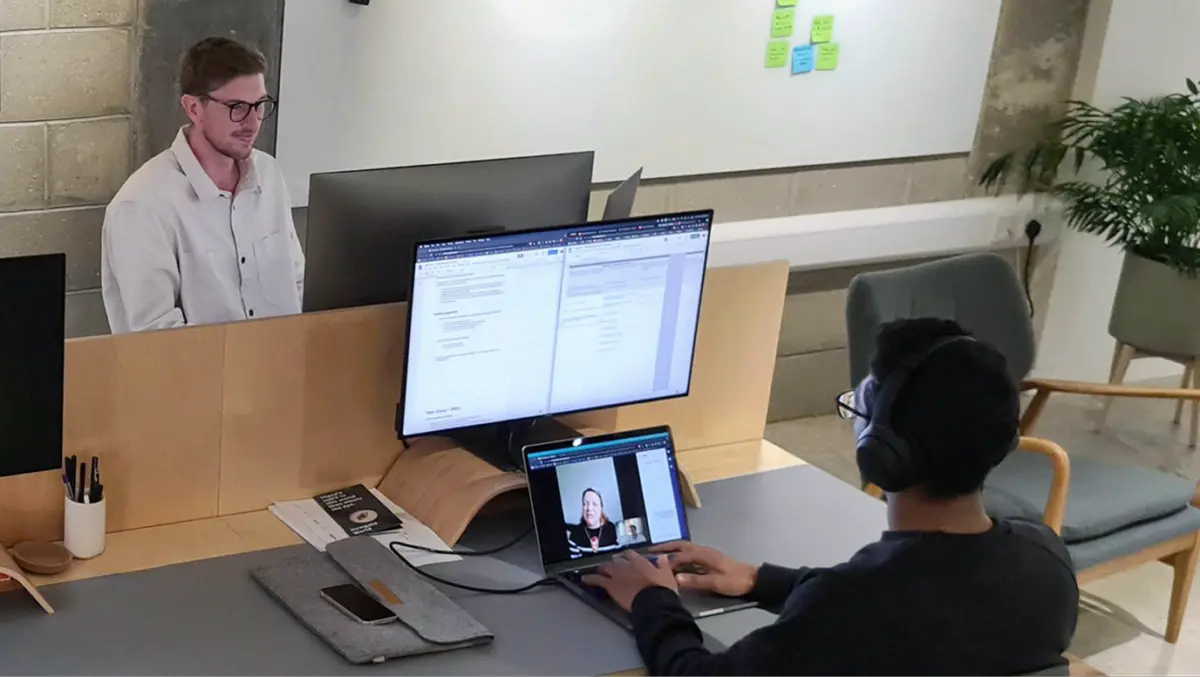 Two designers at a studio desk during a video call