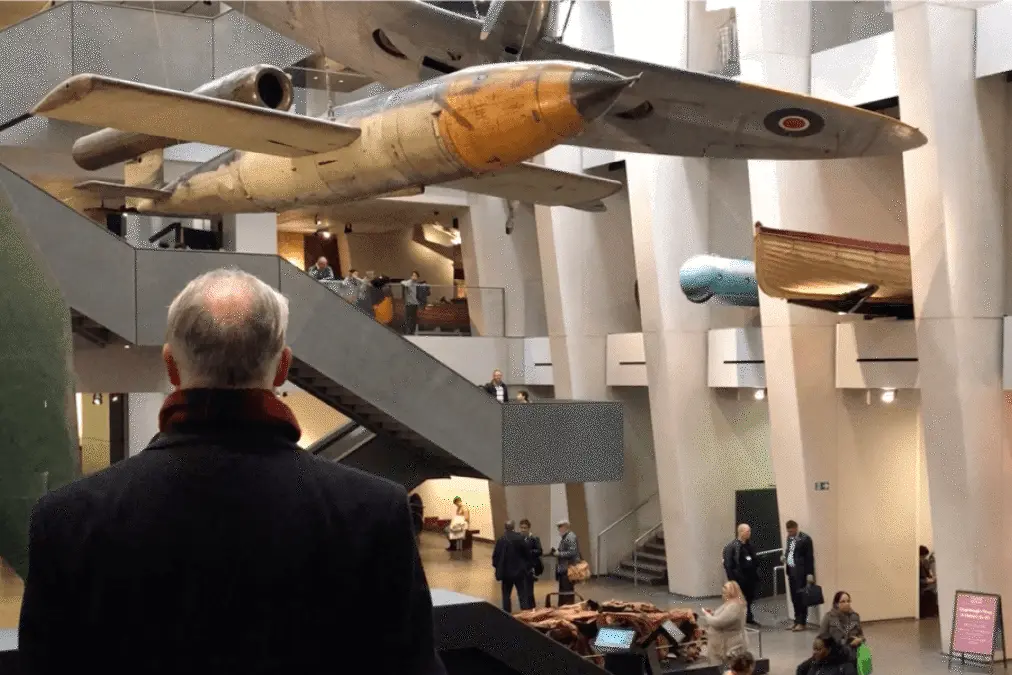 Visitor looking up at aircraft suspended in the museum atrium