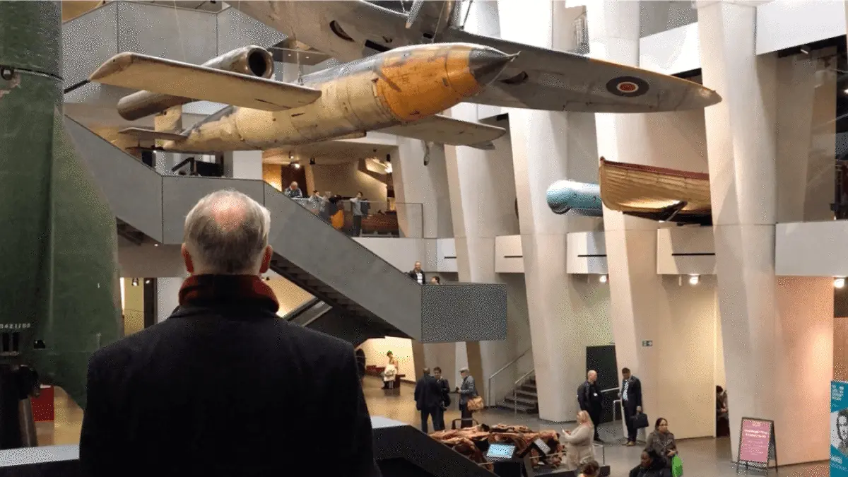 Visitor looking up at aircraft suspended in the museum atrium